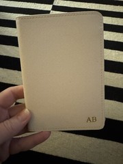 monogrammed passport cover, cream with gold lettering.